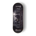 A Yurt fingerboard deck  consisting of a 5-ply maple deck with a Real Wear graphic with a dark gothic design featuring four crows and the word 'Yurt' in a gothic font on the tail. The board has a black background with a detailed print of a skeletal crow under a cloudy sky.