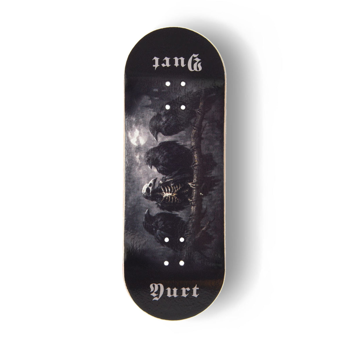 A Yurt fingerboard deck  consisting of a 5-ply maple deck with a Real Wear graphic with a dark gothic design featuring four crows and the word 'Yurt' in a gothic font on the tail. The board has a black background with a detailed print of a skeletal crow under a cloudy sky.
