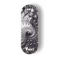 A Yurt fingerboard deck consisting of a 5-ply maple deck with a Real Wear graphic design featuring a black and white fractal spiral design, on a clean white background.