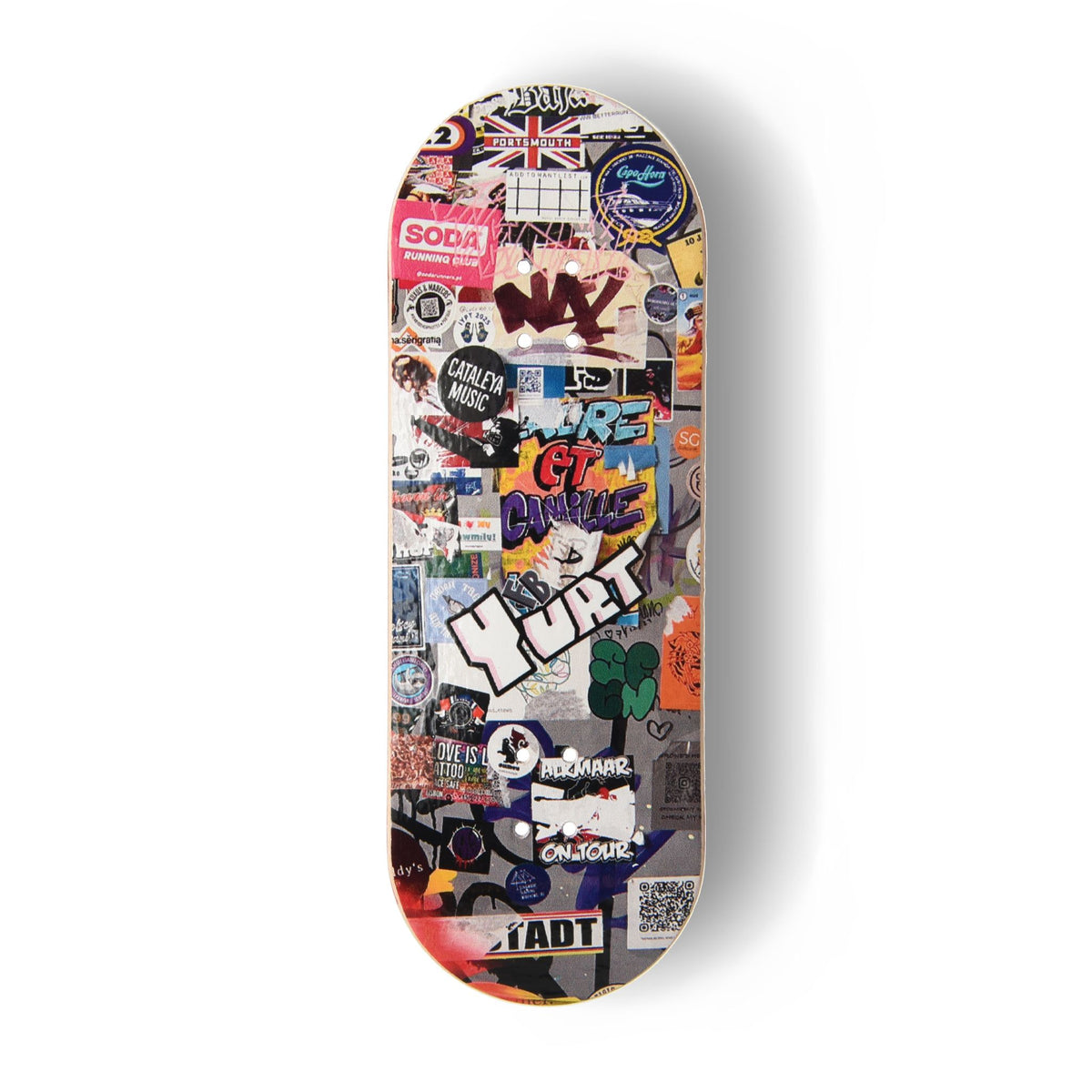A Yurt fingerboard deck consisting of a 5-ply maple deck with a colourful Real Wear graphic design of a graffiti and flyer covered door against a clean white background.