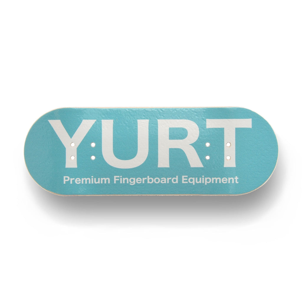 A Yurt fingerboard with 5-ply maple deck with a Real Wear graphic featuring a turquoise fingerboard with the brand name 'YURT' printed in white. Horizontal view.