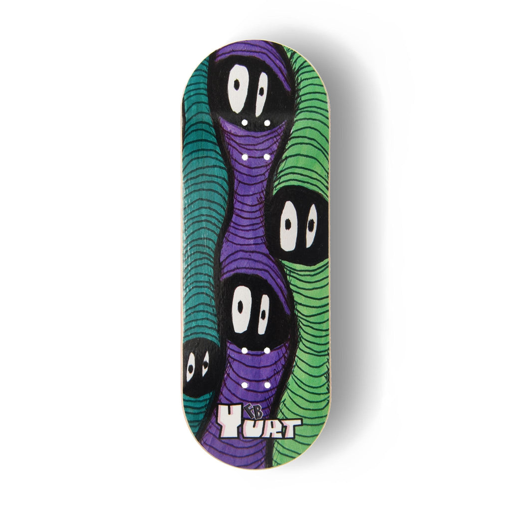 Yurt fingerboard deck consisting of a 5-ply maple deck with a colourful Real Wear graphic design featuring three wavy, faceless green and purple worm figures and the text 'Yurt' at the bottom, shown on a clean white background.