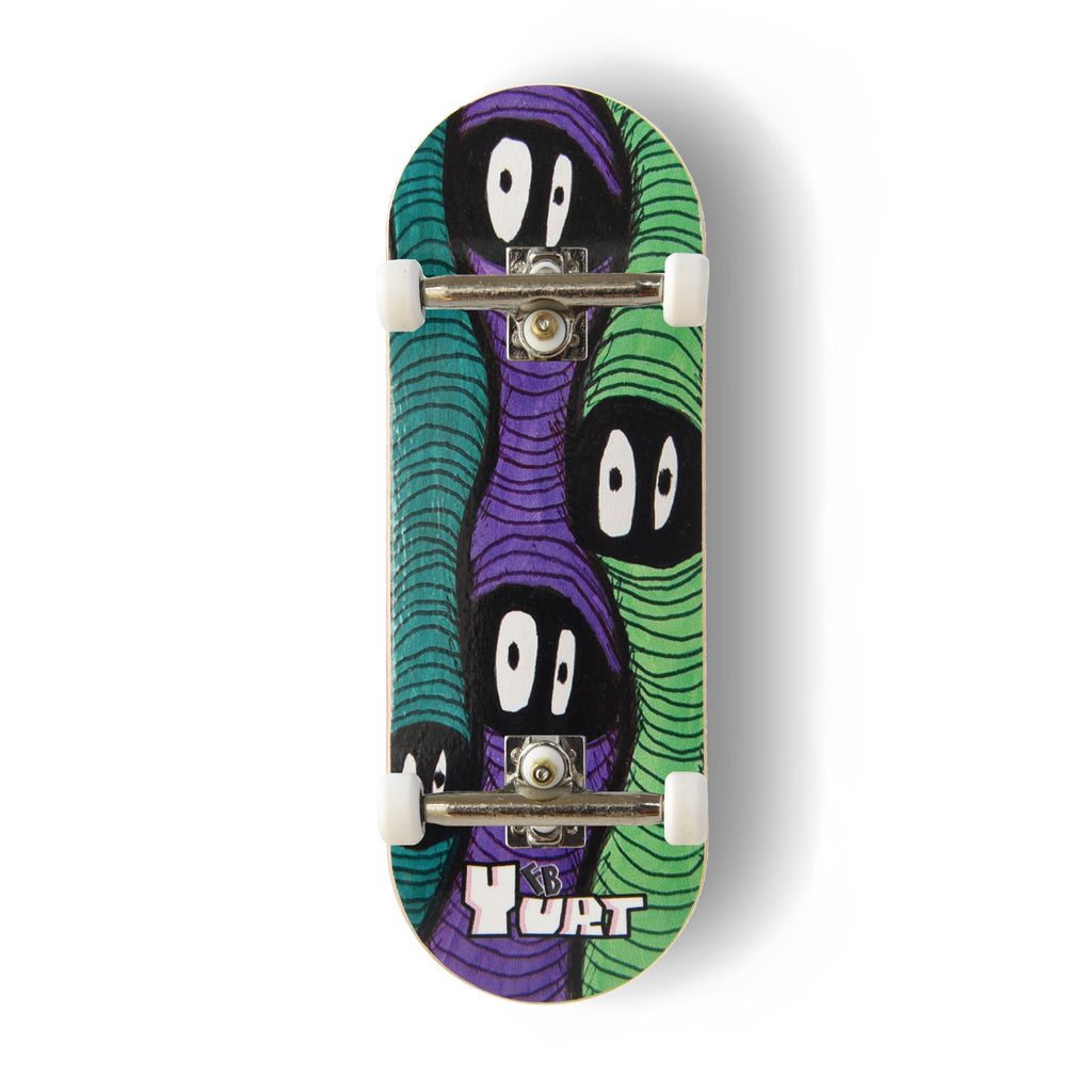Yurt fingerboard complete with silver trucks and white wheels, consisting of a 5-ply maple deck with a colourful Real Wear graphic design featuring three wavy, faceless green and purple worm figures and the text 'Yurt' at the bottom, shown on a clean white background.